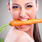 girl with carrots in her teeth