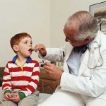 Examination of a child&#39;s throat by a pediatrician