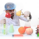 scientist, fruits and flasks with liquid on the table